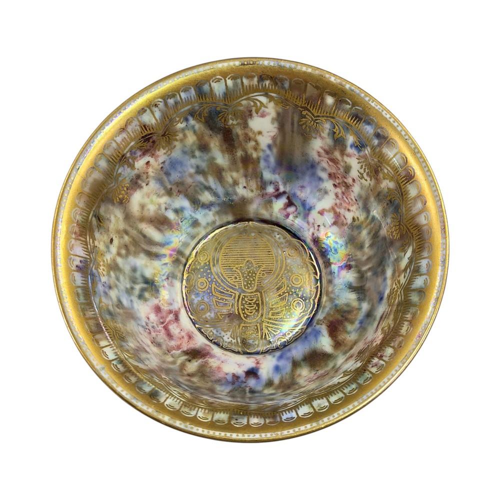 An antique ceramic bowl with a mottled orange lustre glaze on the exterior, decorated with a gold gilded dragon, and a pearlescent interior with a gilded scalloped border. View X