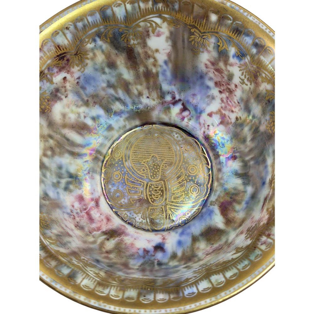 An antique ceramic bowl with a mottled orange lustre glaze on the exterior, decorated with a gold gilded dragon, and a pearlescent interior with a gilded scalloped border. View XI