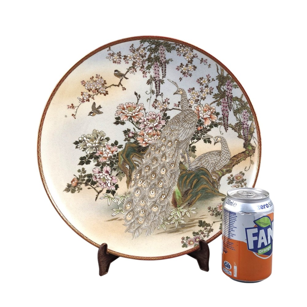 A large circular Japanese Satsuma ceramic charger featuring raised enamel illustrations of peacocks, wisteria, and peonies on a cream crackle glaze background. View II