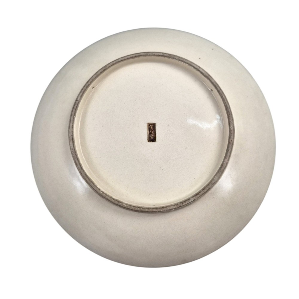 A large circular Japanese Satsuma ceramic charger featuring raised enamel illustrations of peacocks, wisteria, and peonies on a cream crackle glaze background. View IX