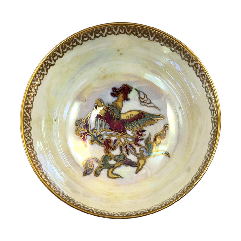 A deep porcelain bowl featuring a mottled green iridescent exterior decorated with gilded butterflies and geometric gold borders around the rim and base. View IX