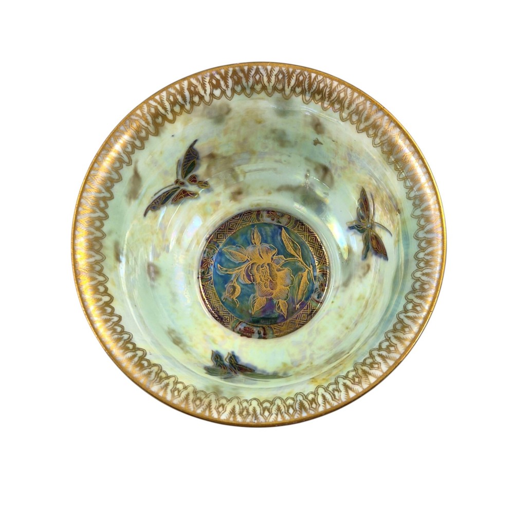 A deep red ceramic bowl with a flared rim, featuring gilded motifs on the exterior and an iridescent opalescent glazed interior. View VI