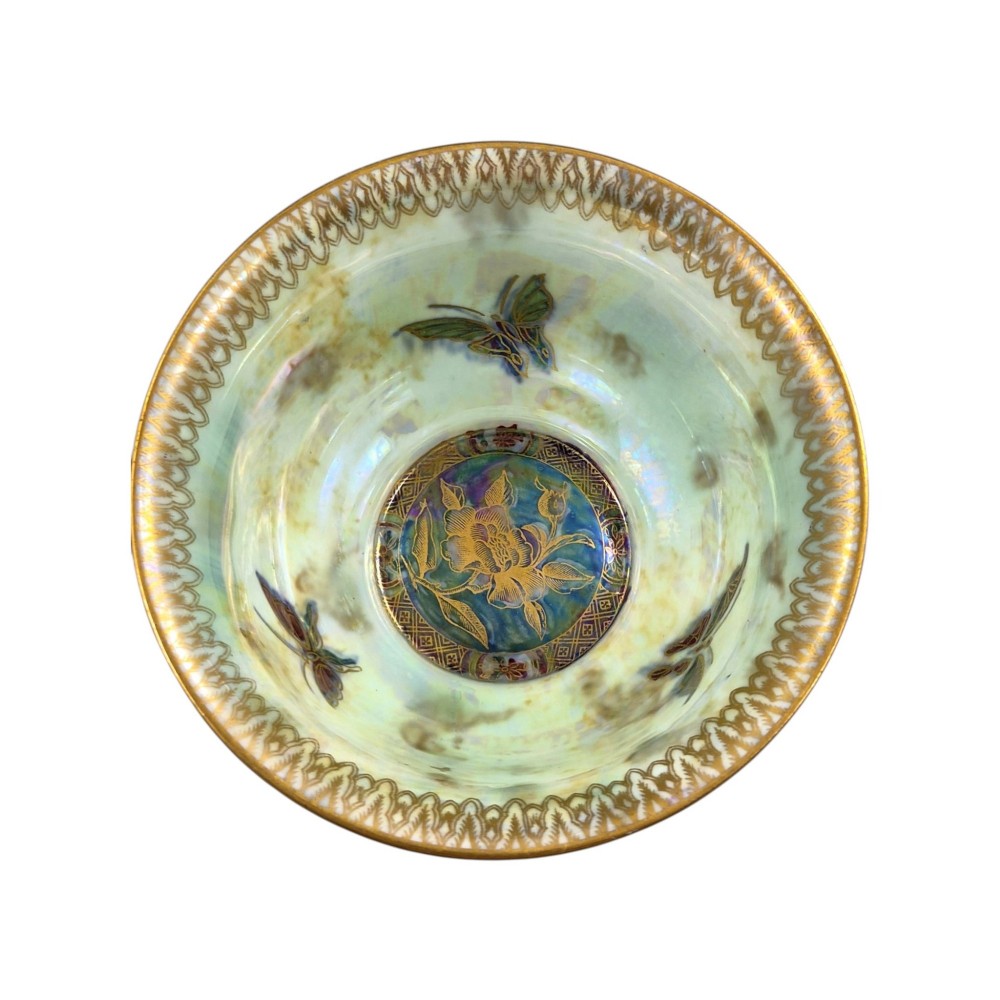 A deep red ceramic bowl with a flared rim, featuring gilded motifs on the exterior and an iridescent opalescent glazed interior. View VII
