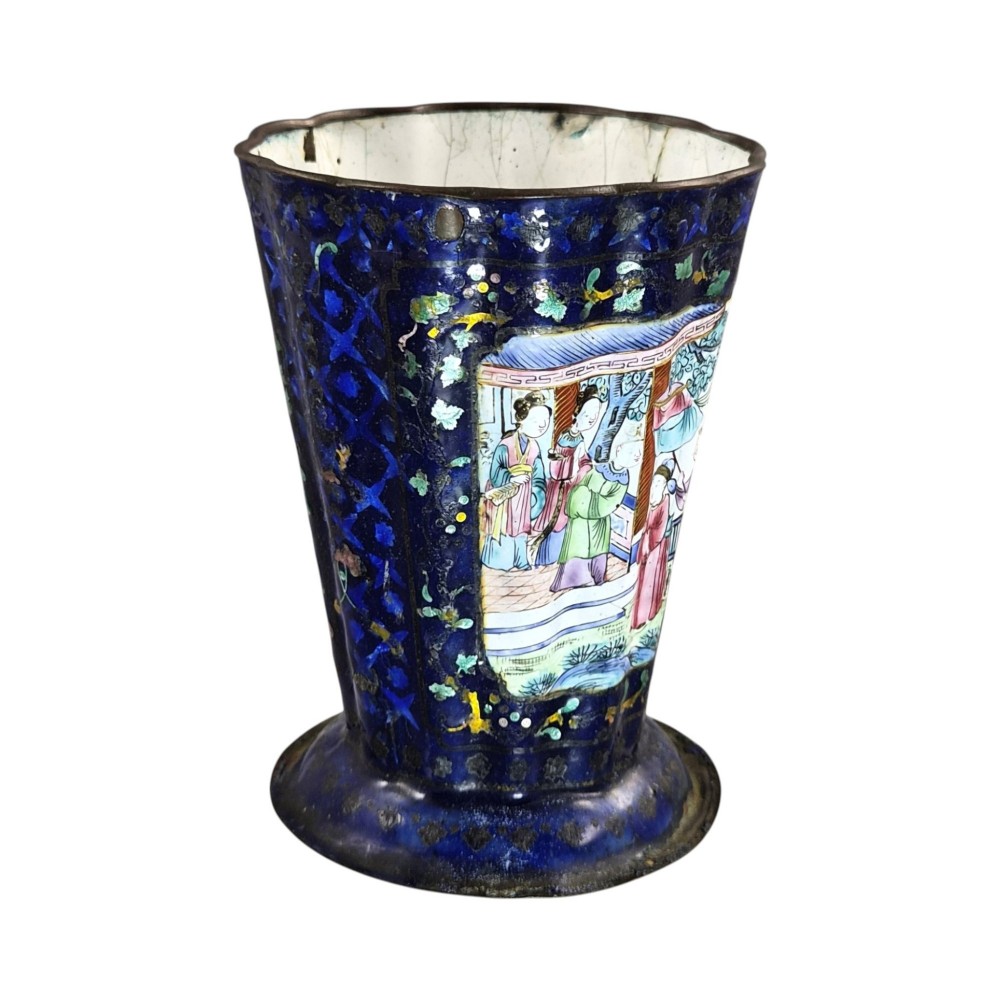 A flared cobalt blue Canton enamel copper vessel painted with a central panel depicting Chinese figures in a courtyard setting. View V