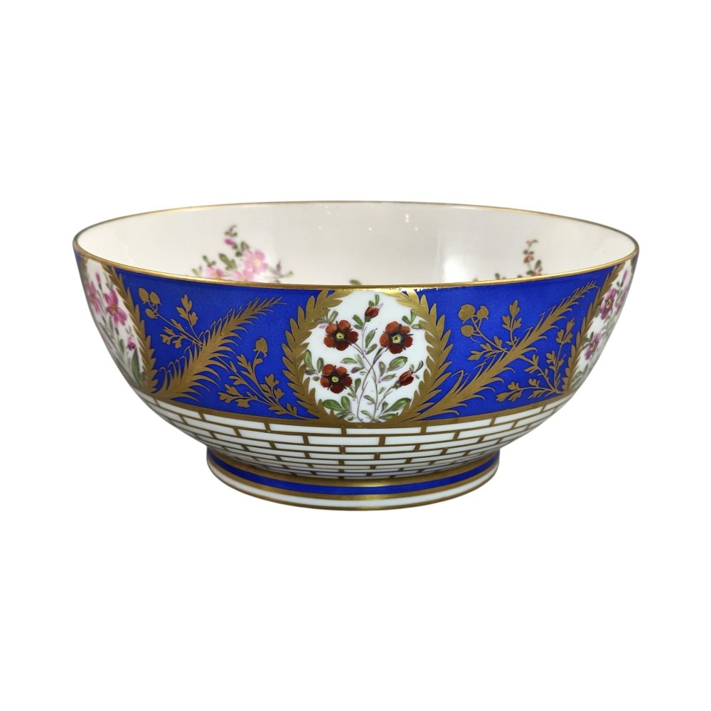 A late 19th-century Samson hard-paste porcelain footed bowl featuring a cobalt blue band with gilded leaf details, hand-painted floral cartouches, and a white brick-patterned base. View VII