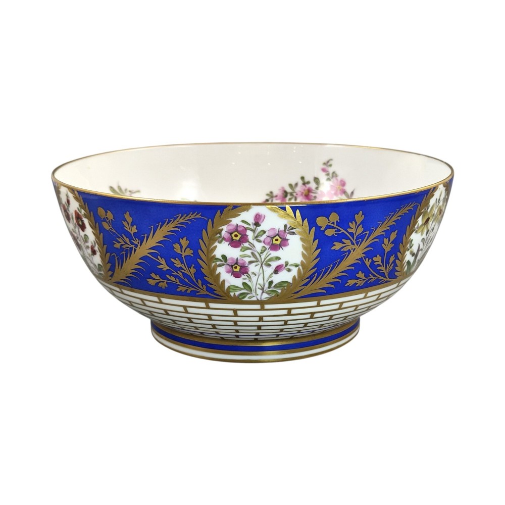 A late 19th-century Samson hard-paste porcelain footed bowl featuring a cobalt blue band with gilded leaf details, hand-painted floral cartouches, and a white brick-patterned base. View VIII