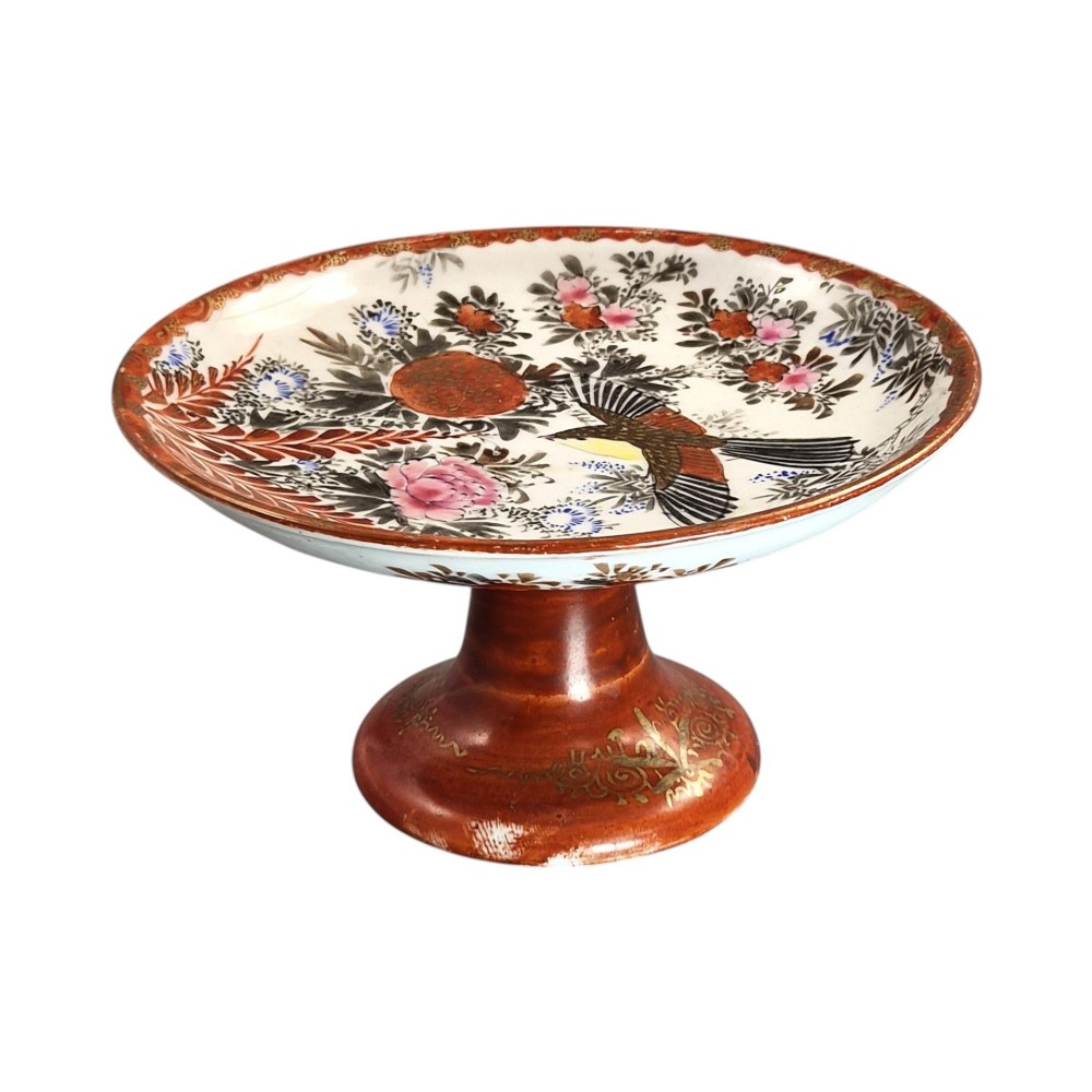 A Japanese Kutani porcelain teapot decorated with iron-red enamel, gilded accents, and hand-painted figurative scenes, seated on a matching pedestal stand. View II