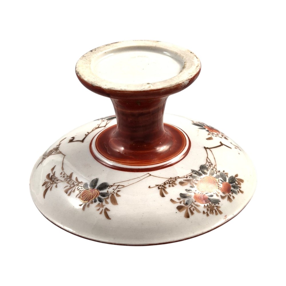A Japanese Kutani porcelain teapot decorated with iron-red enamel, gilded accents, and hand-painted figurative scenes, seated on a matching pedestal stand. View V