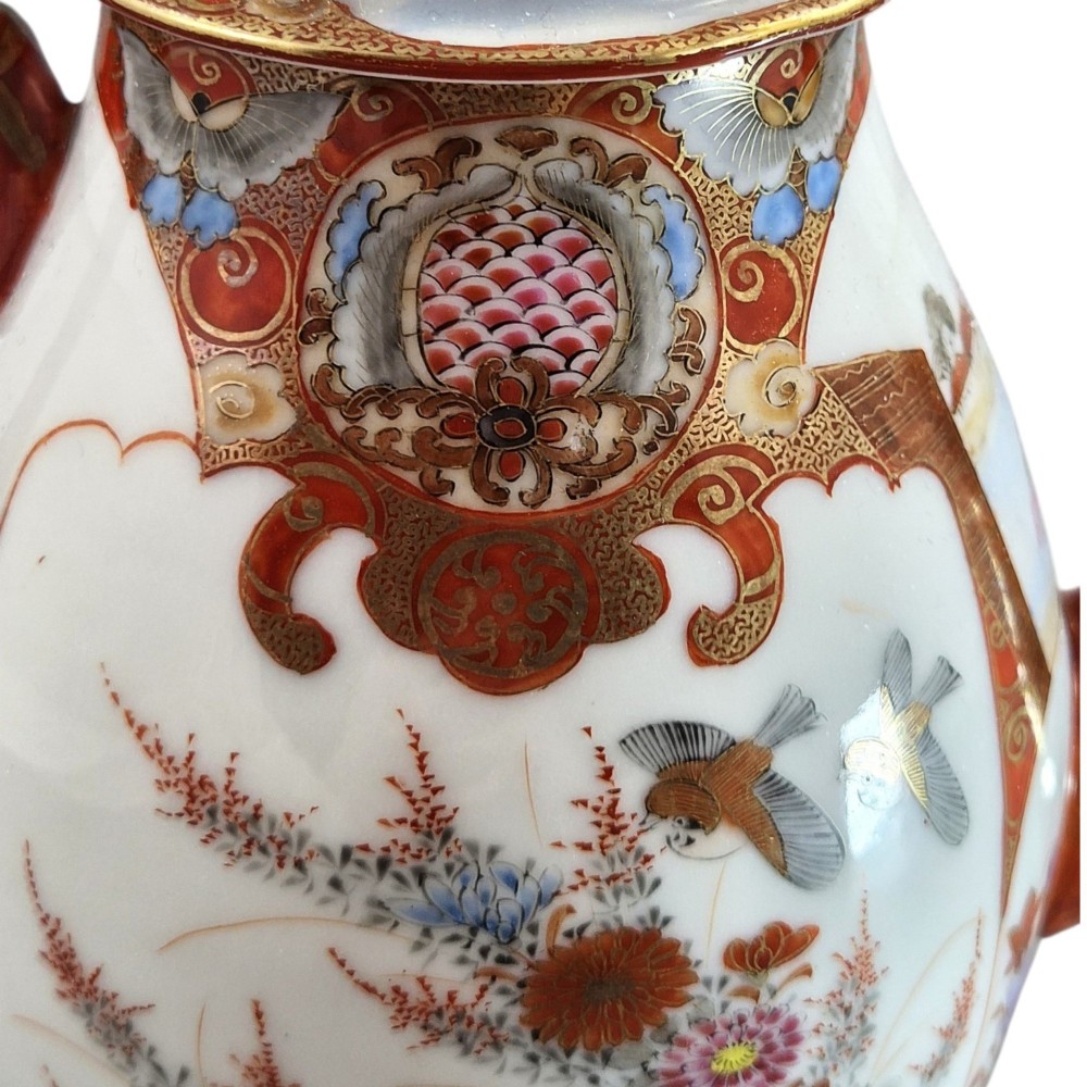 A Japanese Kutani porcelain teapot decorated with iron-red enamel, gilded accents, and hand-painted figurative scenes, seated on a matching pedestal stand. View XIII