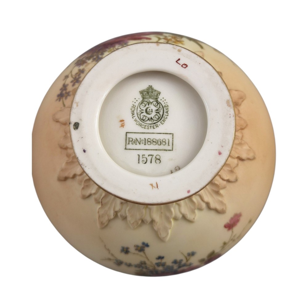 A symmetrical pair of Edwardian Royal Worcester blush ivory porcelain vases featuring gilded dolphin handles, relief-moulded necks, and hand-painted floral decoration. View VII