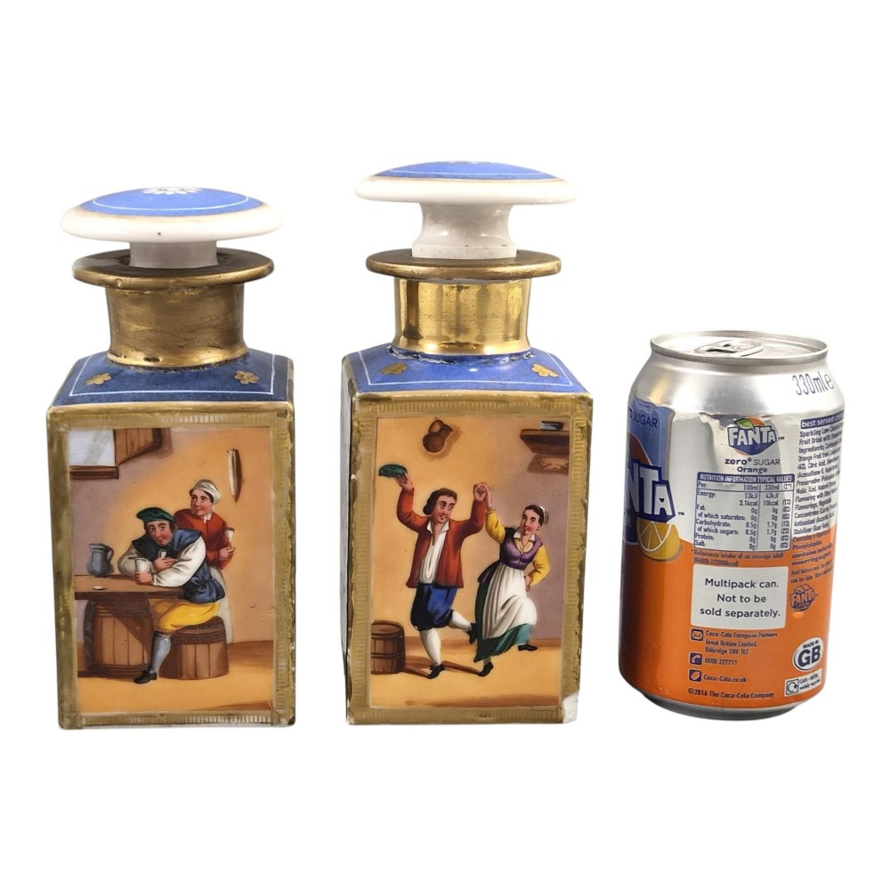 A pair of square 19th-century French porcelain perfume bottles featuring cobalt blue tops, gilded necks, and hand-painted genre scenes of figures in tavern settings. View III