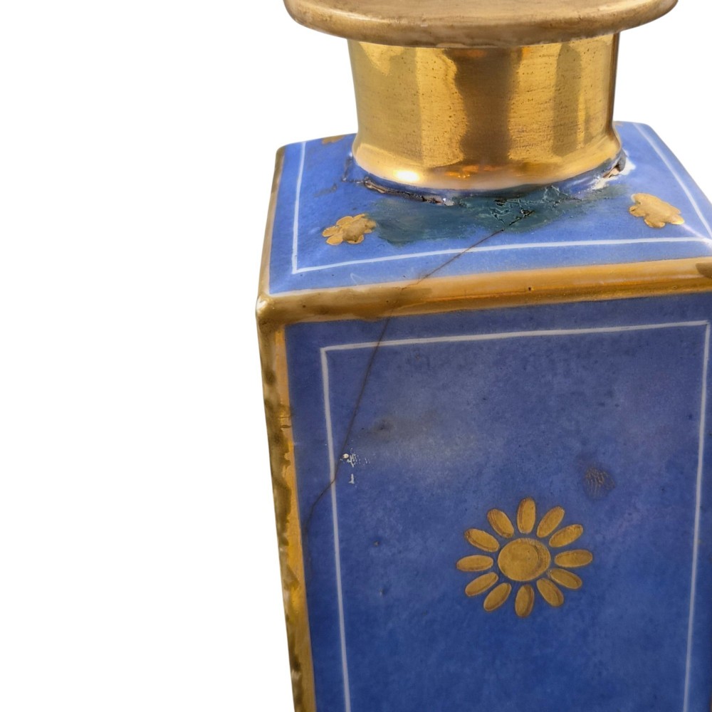 A pair of square 19th-century French porcelain perfume bottles featuring cobalt blue tops, gilded necks, and hand-painted genre scenes of figures in tavern settings. View IV