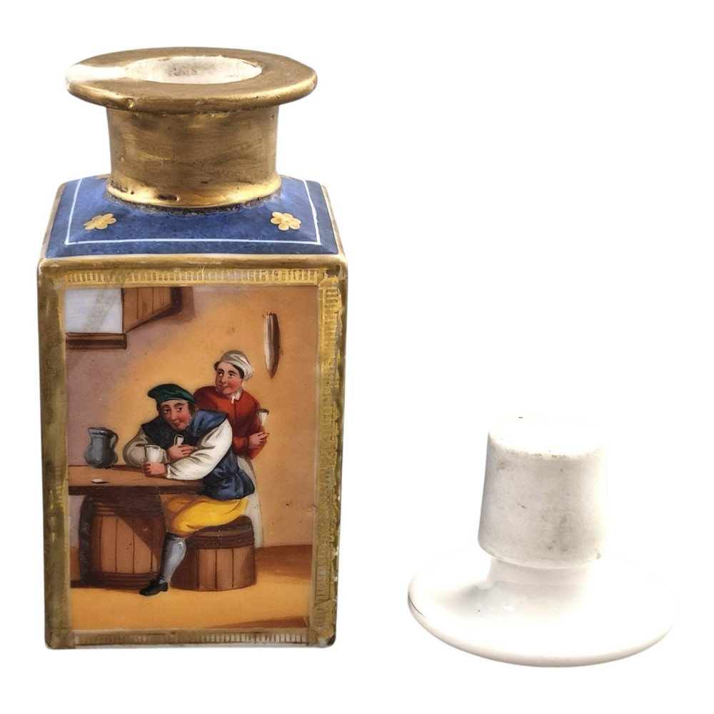 A pair of square 19th-century French porcelain perfume bottles featuring cobalt blue tops, gilded necks, and hand-painted genre scenes of figures in tavern settings. View VIII