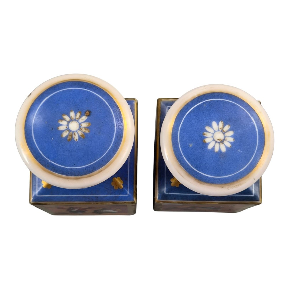 A pair of square 19th-century French porcelain perfume bottles featuring cobalt blue tops, gilded necks, and hand-painted genre scenes of figures in tavern settings. View XIII