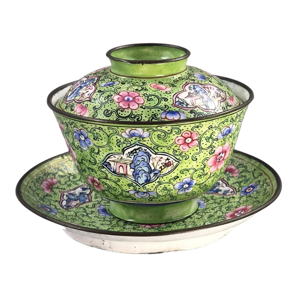 A Chinese Canton enamel gaiwan featuring a green ground with pink floral scrolls and landscape cartouches, complete with lid and matching saucer. View IV