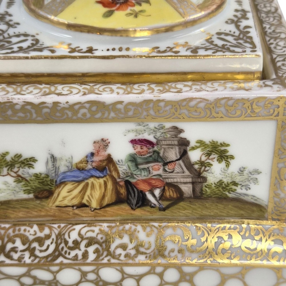 A pair of late nineteenth-century Dresden porcelain urns featuring yellow ground, hand-painted romantic scenes, gilded handles, and square pedestal bases. View XII