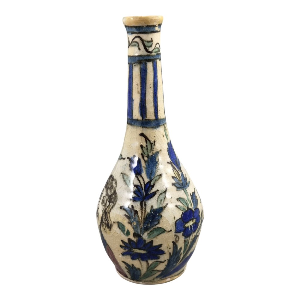 An Iranian Qajar ceramic bottle vase featuring an elongated neck, cream crackle glaze, and hand-painted blue and purple figurative portrait and floral motifs. View II
