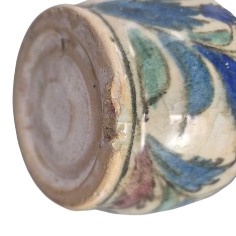 An Iranian Qajar ceramic bottle vase featuring an elongated neck, cream crackle glaze, and hand-painted blue and purple figurative portrait and floral motifs. View VIII