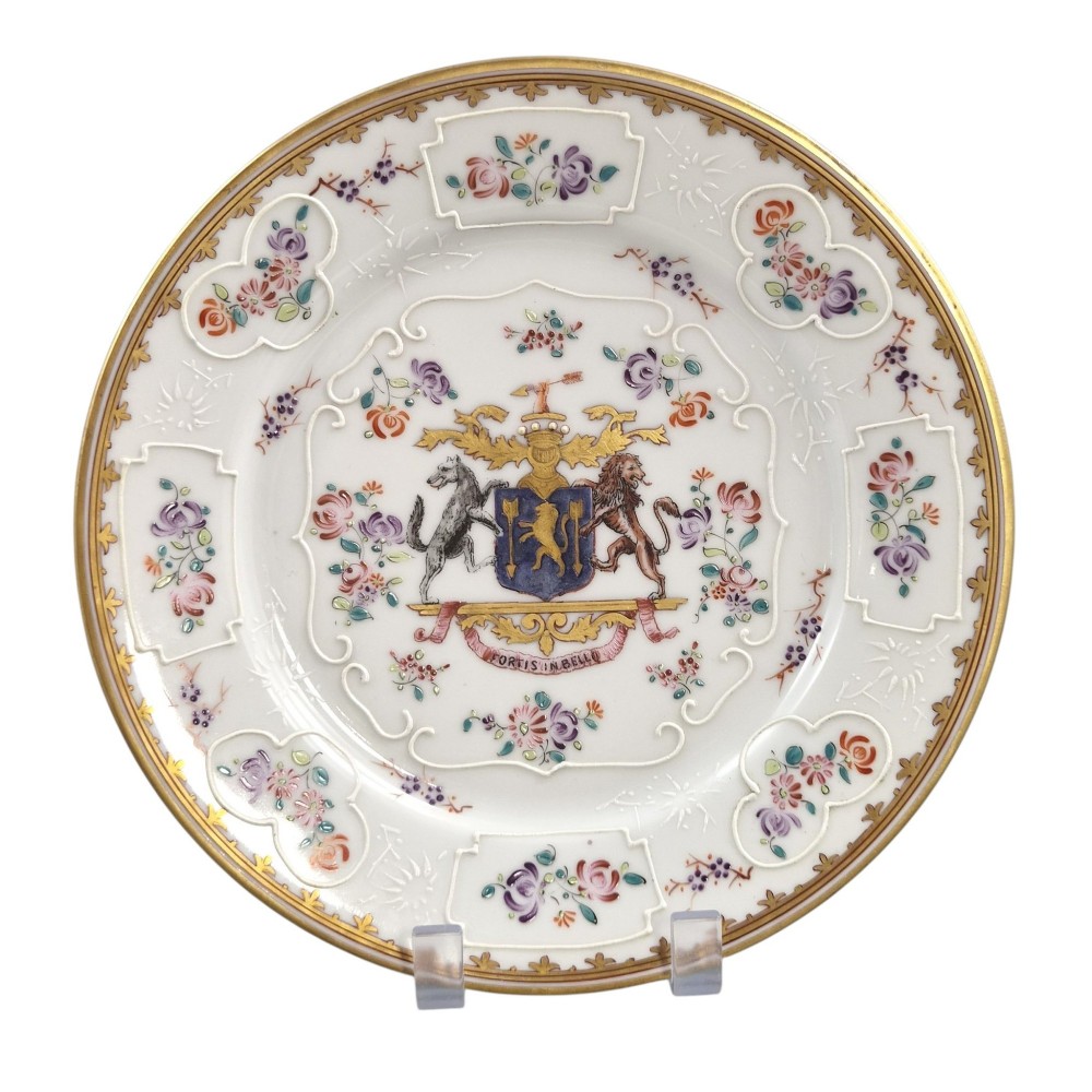 A pair of circular white porcelain plates featuring a central coat of arms, hand-painted floral sprays, raised enamel details, and gilded rims. View II