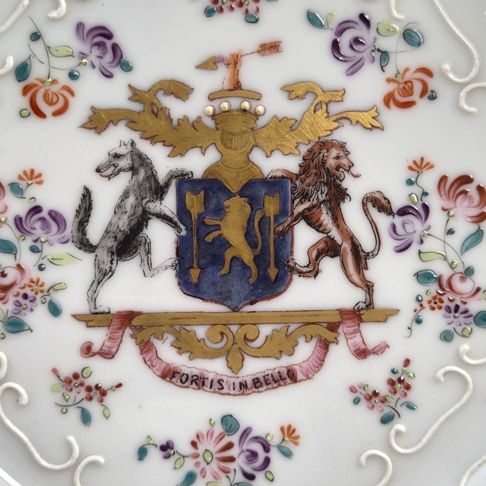 A pair of circular white porcelain plates featuring a central coat of arms, hand-painted floral sprays, raised enamel details, and gilded rims. View III