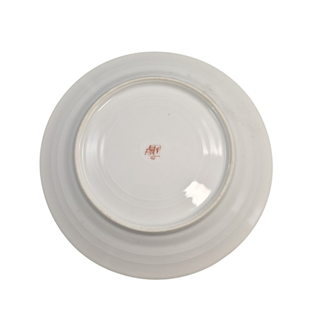 A pair of circular white porcelain plates featuring a central coat of arms, hand-painted floral sprays, raised enamel details, and gilded rims. View V