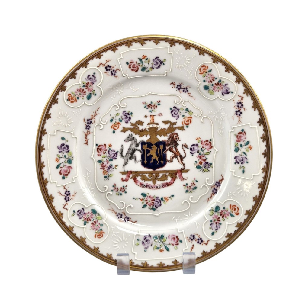 A pair of circular white porcelain plates featuring a central coat of arms, hand-painted floral sprays, raised enamel details, and gilded rims. View VI