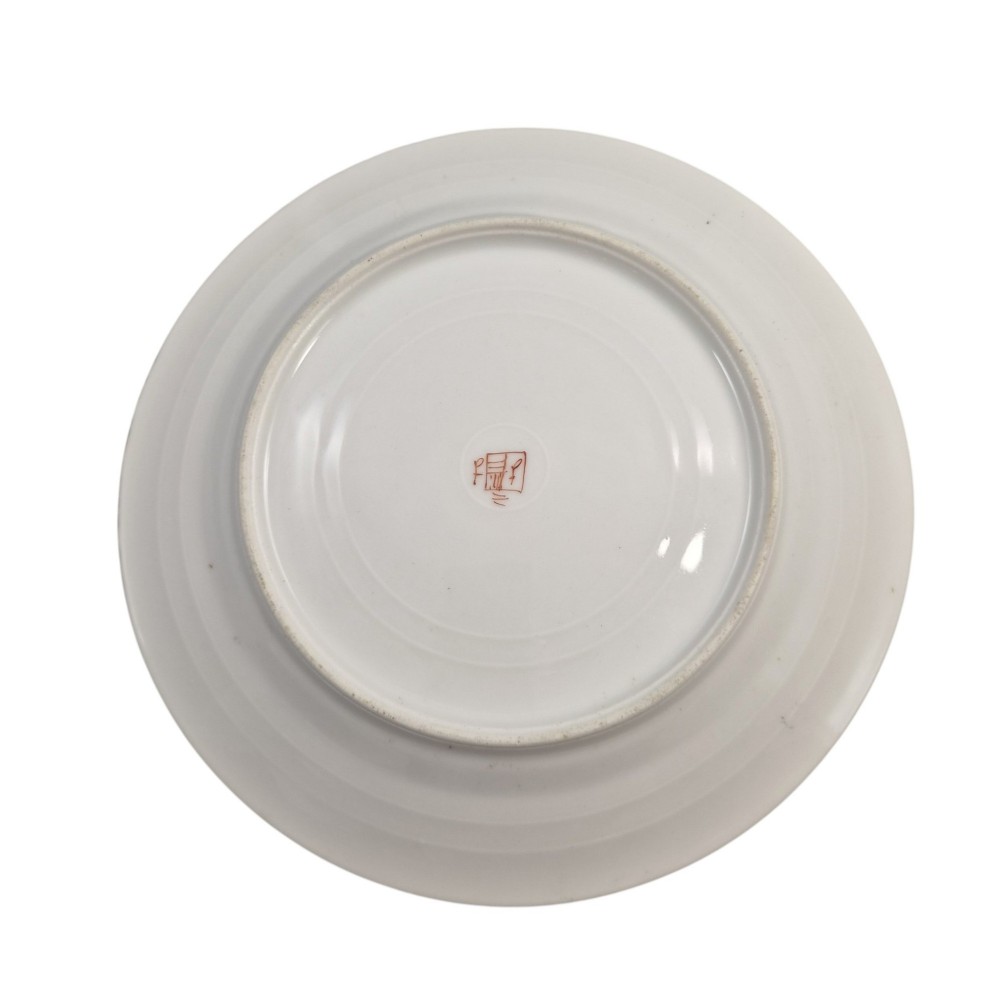 A pair of circular white porcelain plates featuring a central coat of arms, hand-painted floral sprays, raised enamel details, and gilded rims. View IX