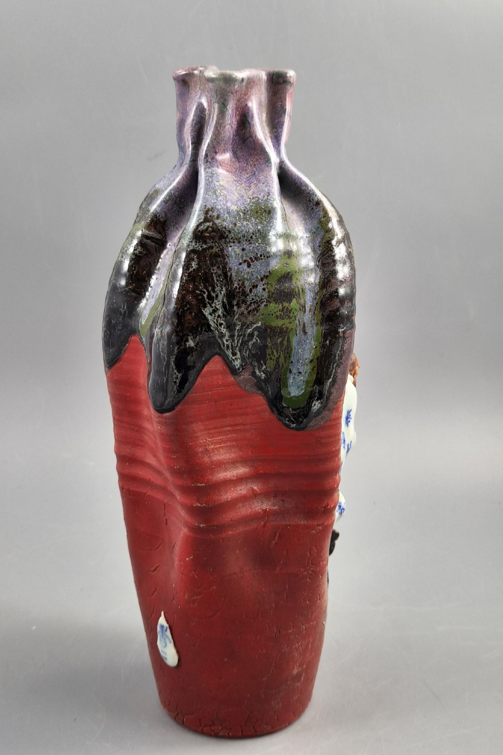 A Japanese Sumida Gawa terracotta vase with applied high-relief figures of a sage and child beneath a dripping lavender and dark flambe glaze. View VI