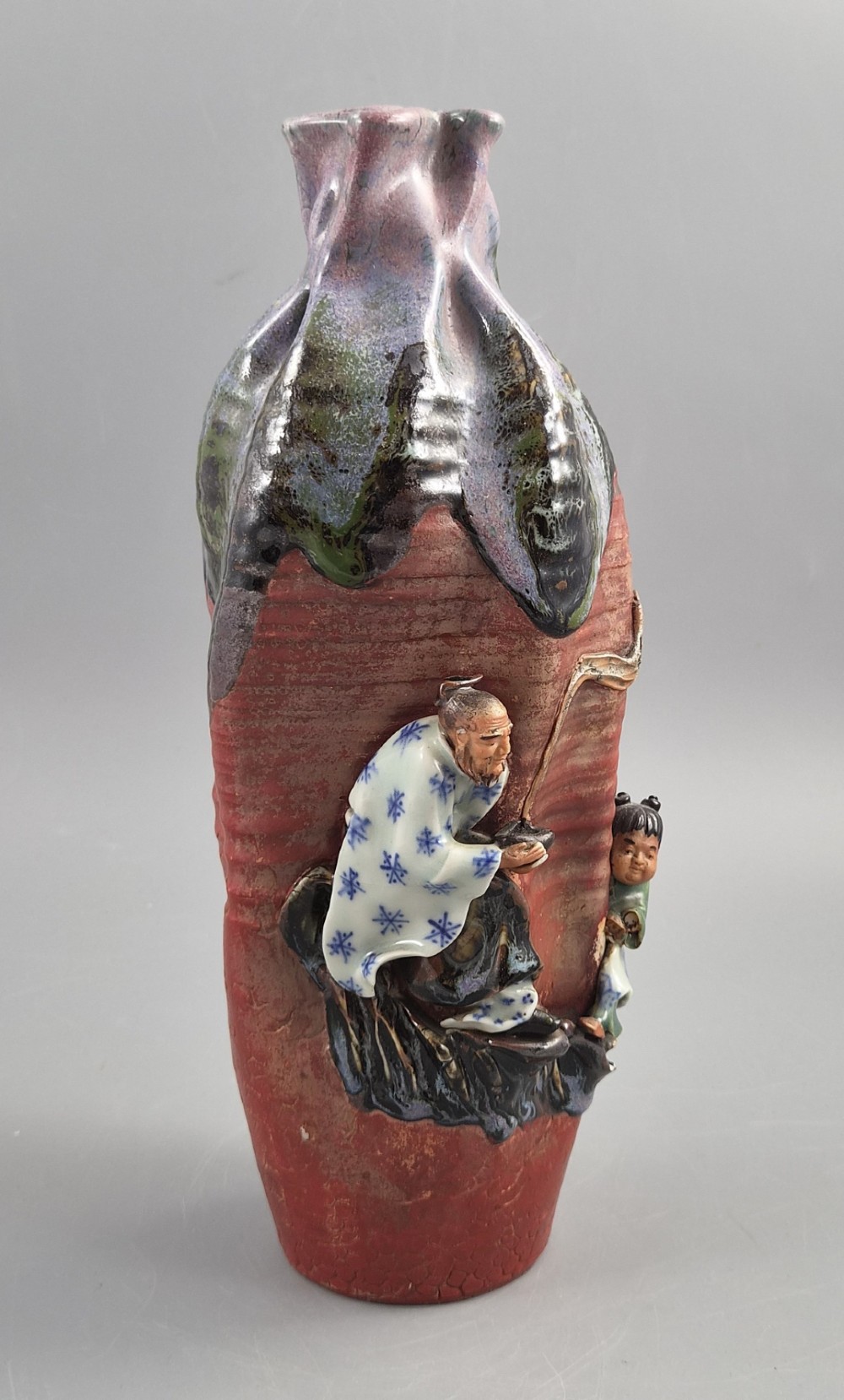 A Japanese Sumida Gawa terracotta vase with applied high-relief figures of a sage and child beneath a dripping lavender and dark flambe glaze. View VIII