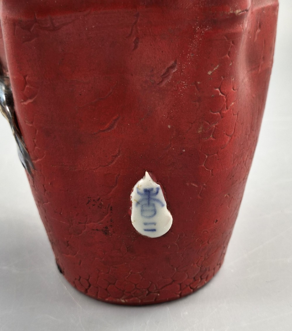 A Japanese Sumida Gawa terracotta vase with applied high-relief figures of a sage and child beneath a dripping lavender and dark flambe glaze. View IX