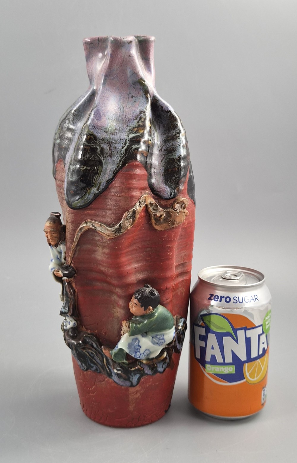 A Japanese Sumida Gawa terracotta vase with applied high-relief figures of a sage and child beneath a dripping lavender and dark flambe glaze. View XIII