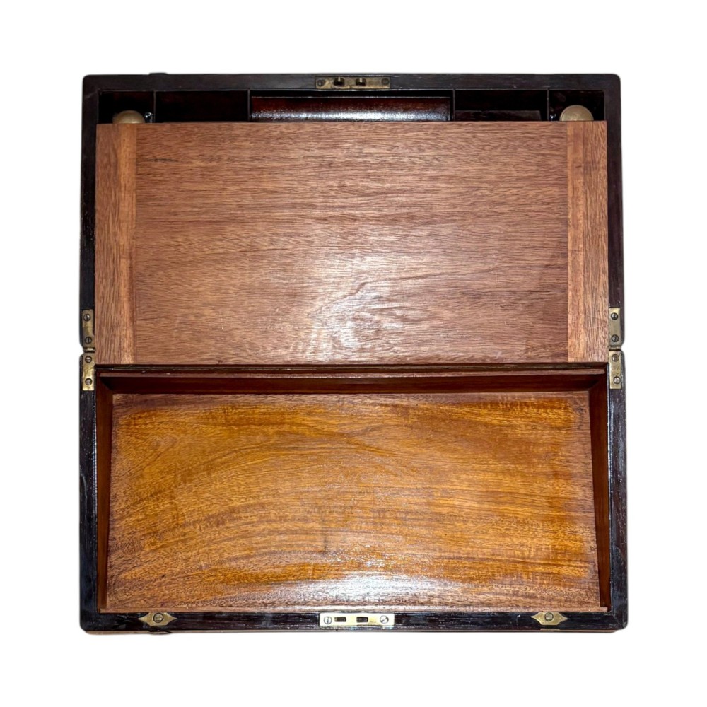 An open Victorian mahogany writing slope featuring flush brass corner bindings, internal pen compartments, and a green gilt-tooled leather writing surface. View III