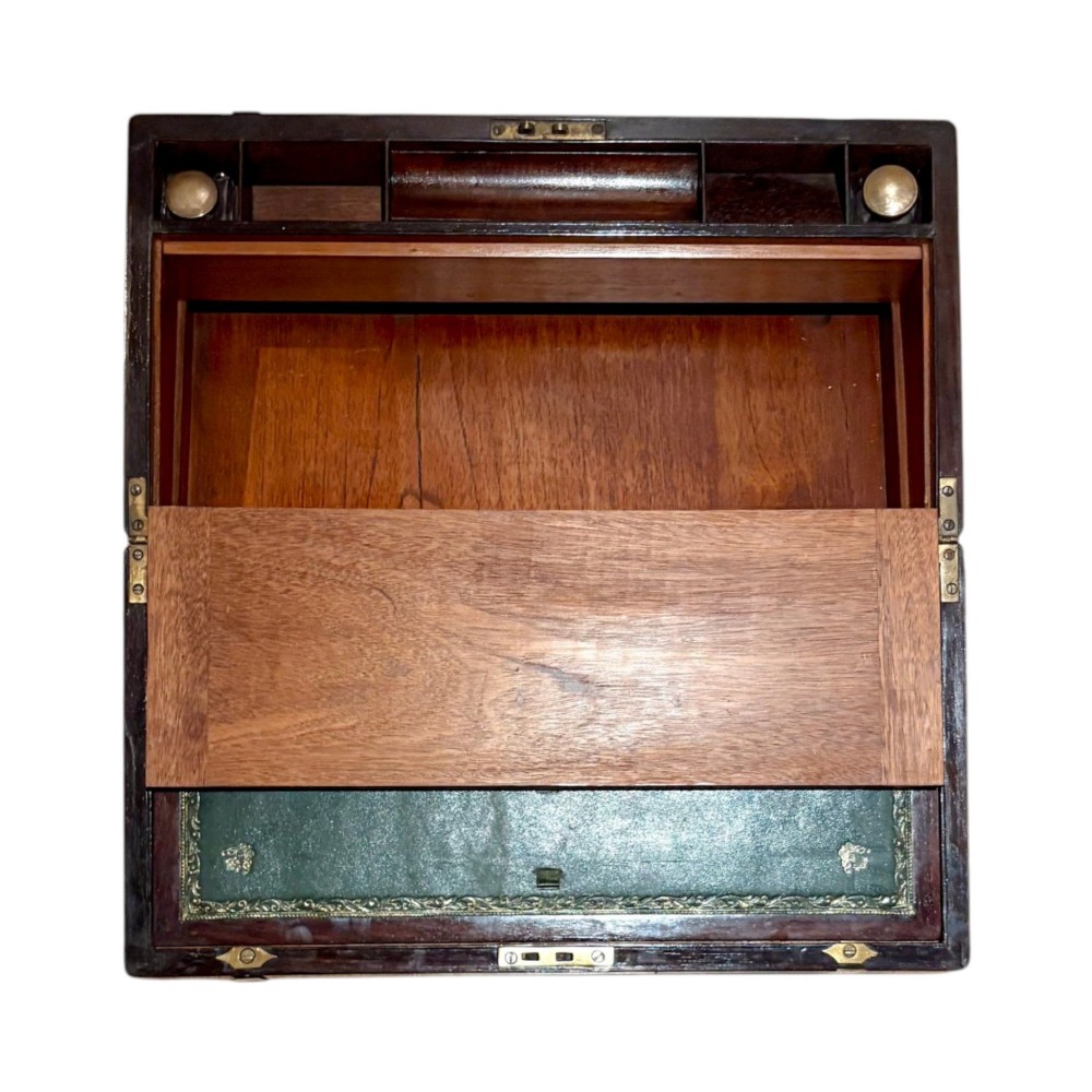 An open Victorian mahogany writing slope featuring flush brass corner bindings, internal pen compartments, and a green gilt-tooled leather writing surface. View IV