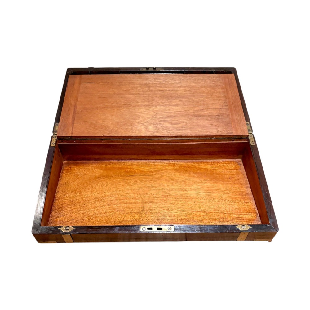 An open Victorian mahogany writing slope featuring flush brass corner bindings, internal pen compartments, and a green gilt-tooled leather writing surface. View V