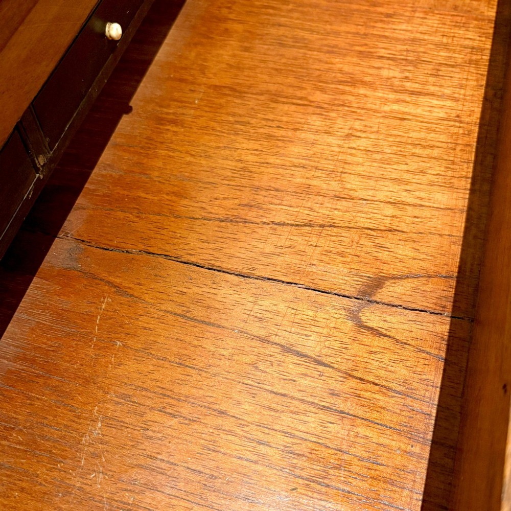 An open Victorian mahogany writing slope featuring flush brass corner bindings, internal pen compartments, and a green gilt-tooled leather writing surface. View X
