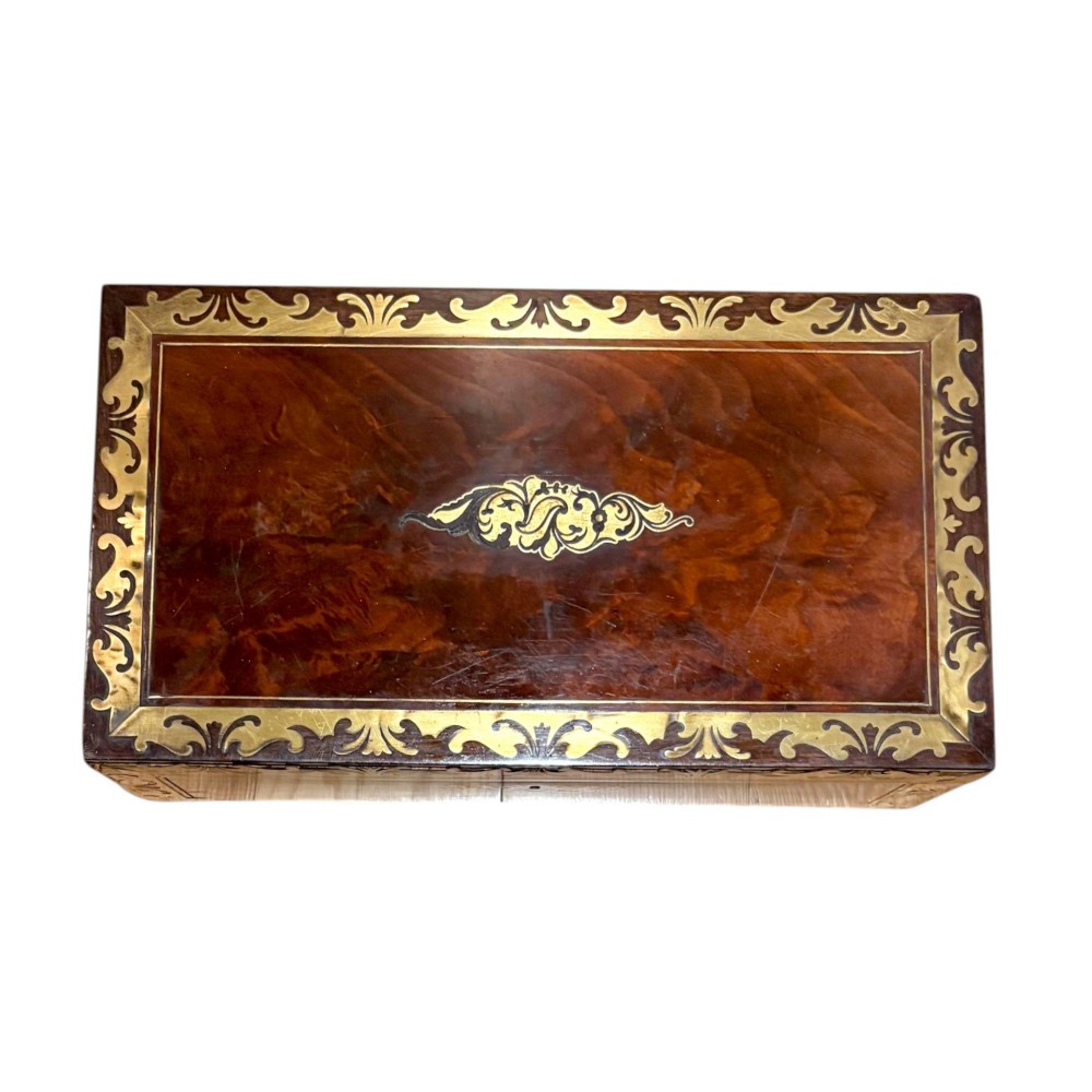 A rectangular dark mahogany writing slope featuring ornate brass scroll inlay around the borders and lid. View V