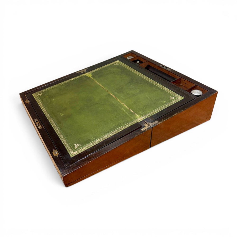 A rectangular dark mahogany writing slope featuring ornate brass scroll inlay around the borders and lid. View VI
