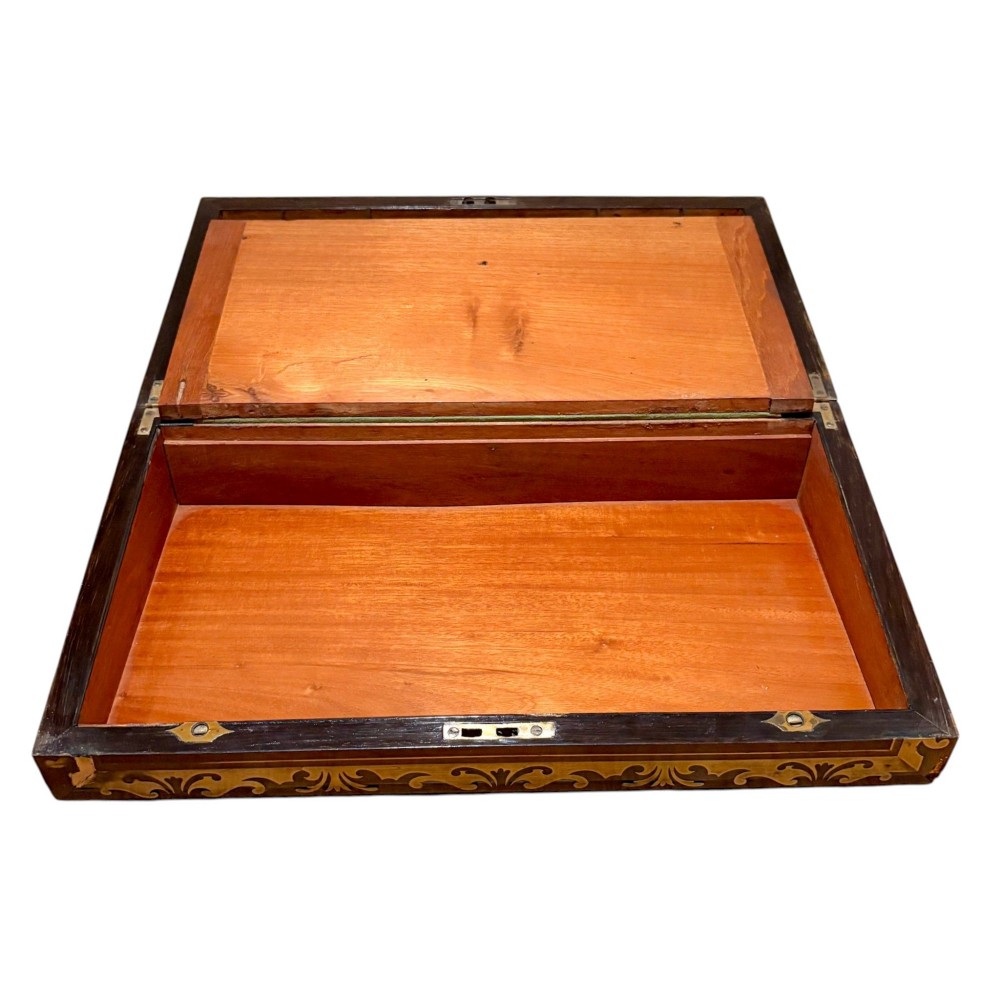 A rectangular dark mahogany writing slope featuring ornate brass scroll inlay around the borders and lid. View VII