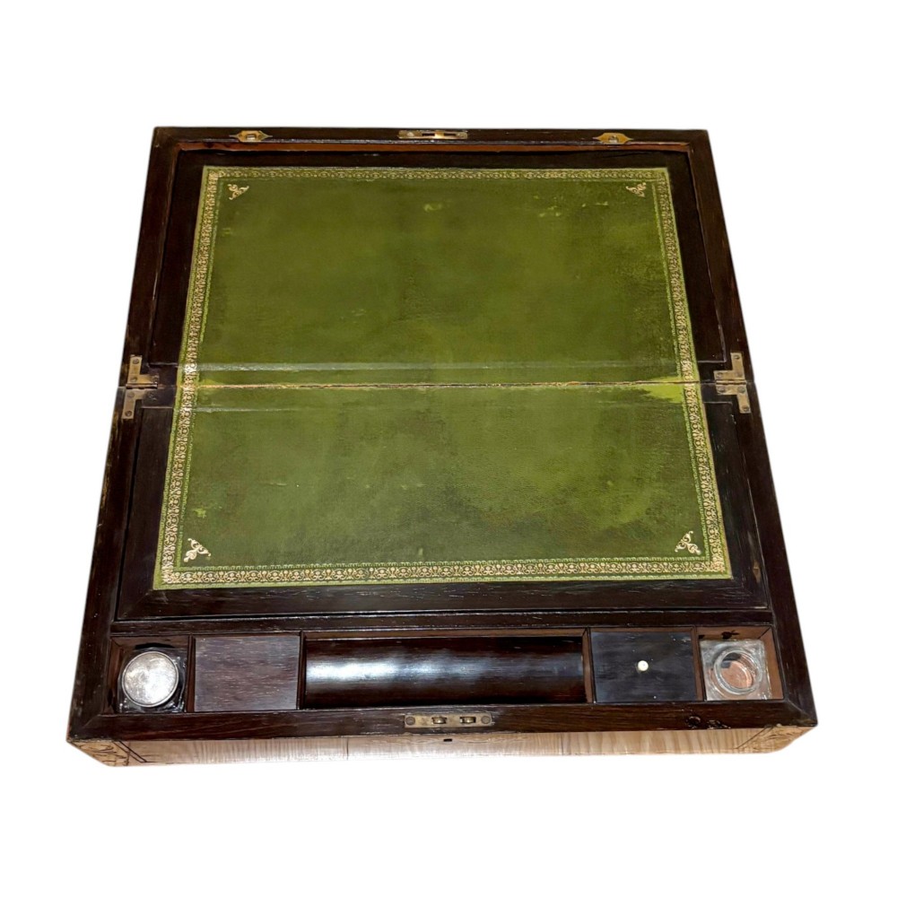 A rectangular dark mahogany writing slope featuring ornate brass scroll inlay around the borders and lid. View VIII