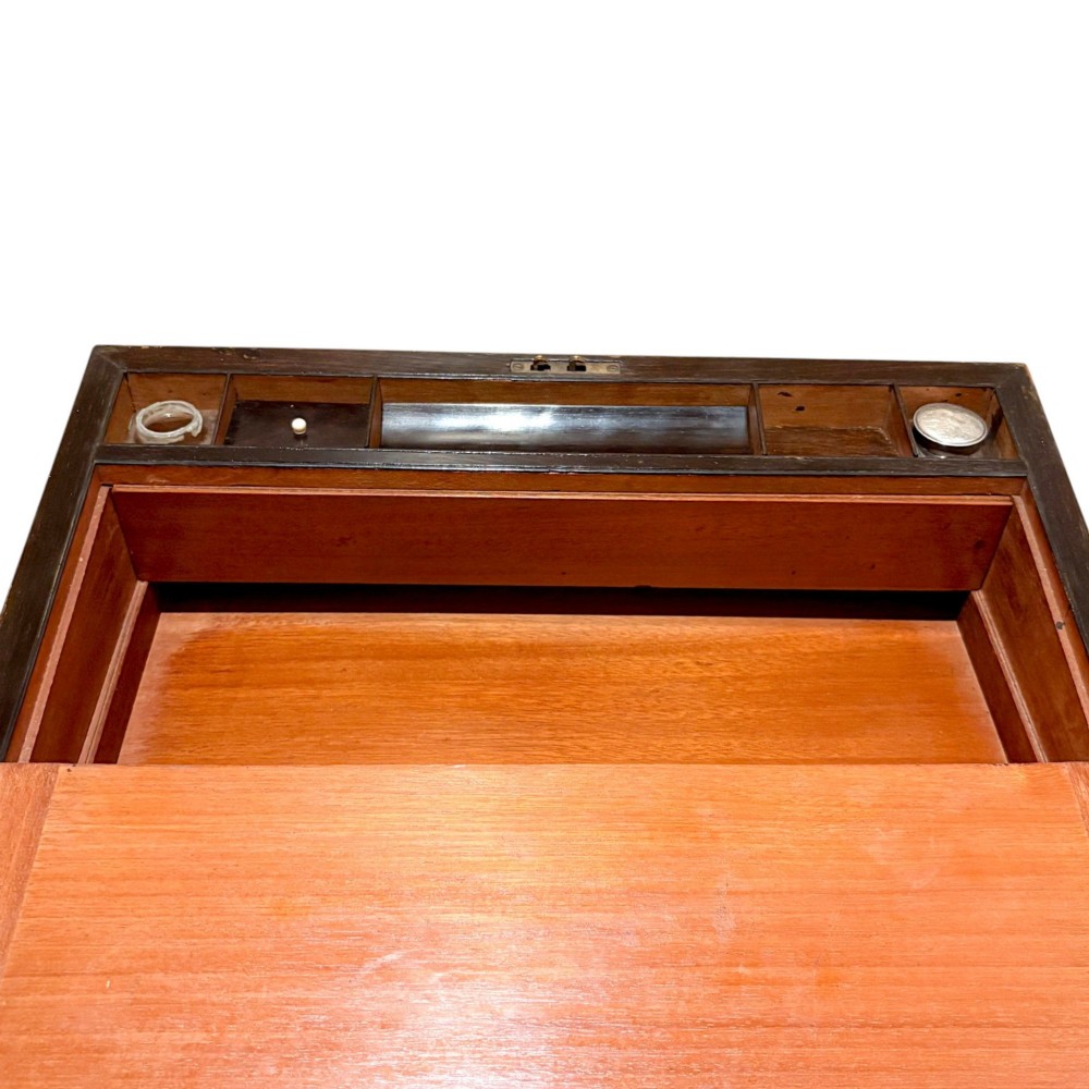 A rectangular dark mahogany writing slope featuring ornate brass scroll inlay around the borders and lid. View IX