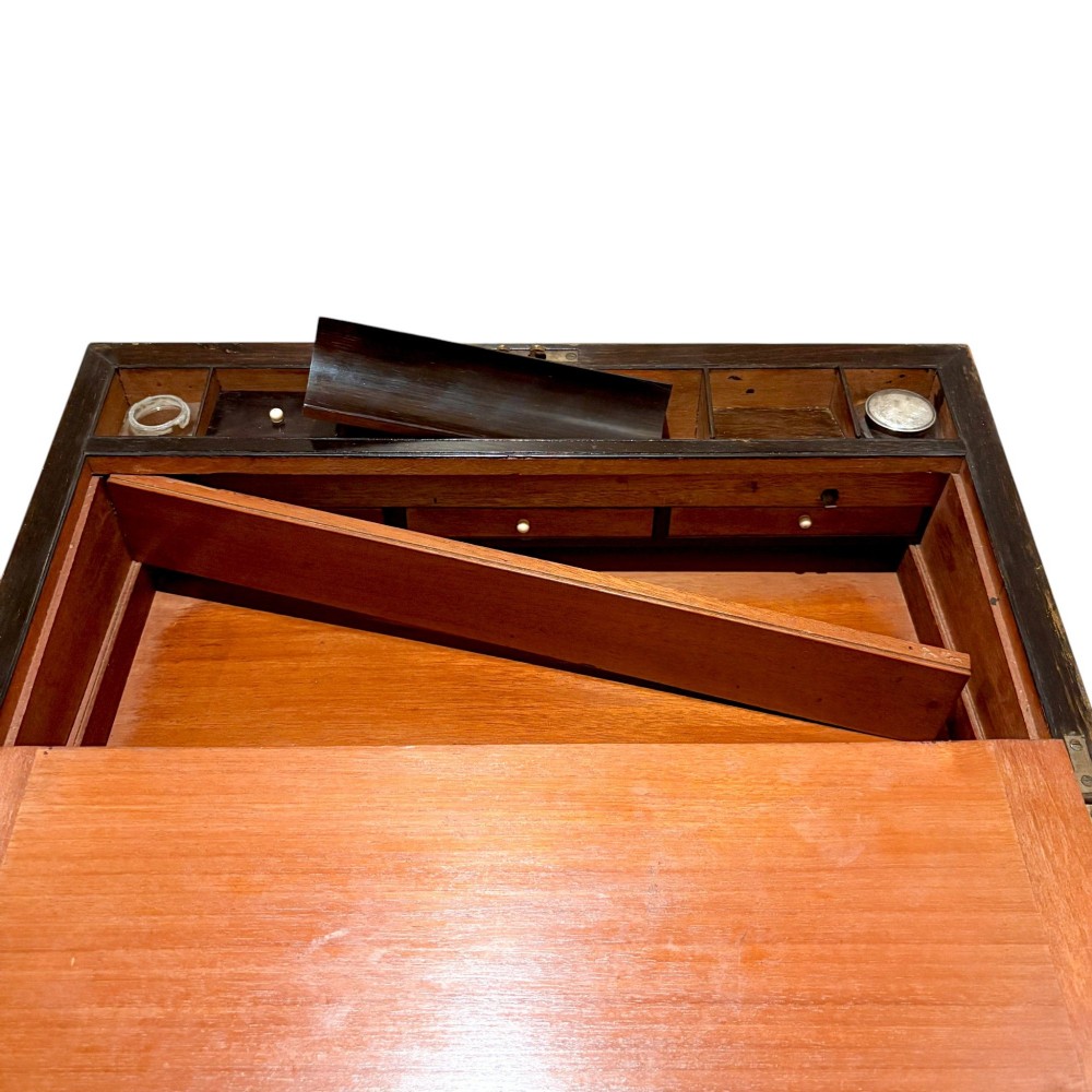 A rectangular dark mahogany writing slope featuring ornate brass scroll inlay around the borders and lid. View XII