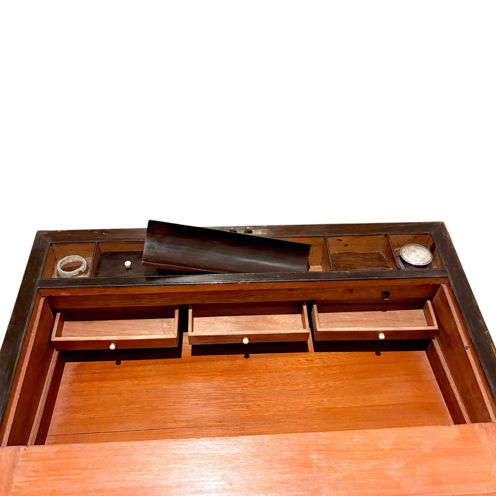A rectangular dark mahogany writing slope featuring ornate brass scroll inlay around the borders and lid. View XIII