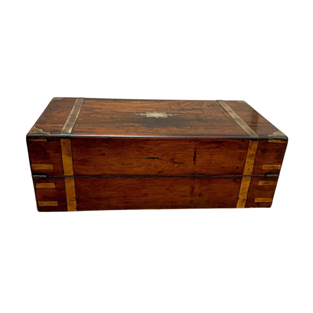 A closed rectangular Victorian rosewood writing slope featuring brass strapping, brass corner mounts, and a central brass escutcheon. View II