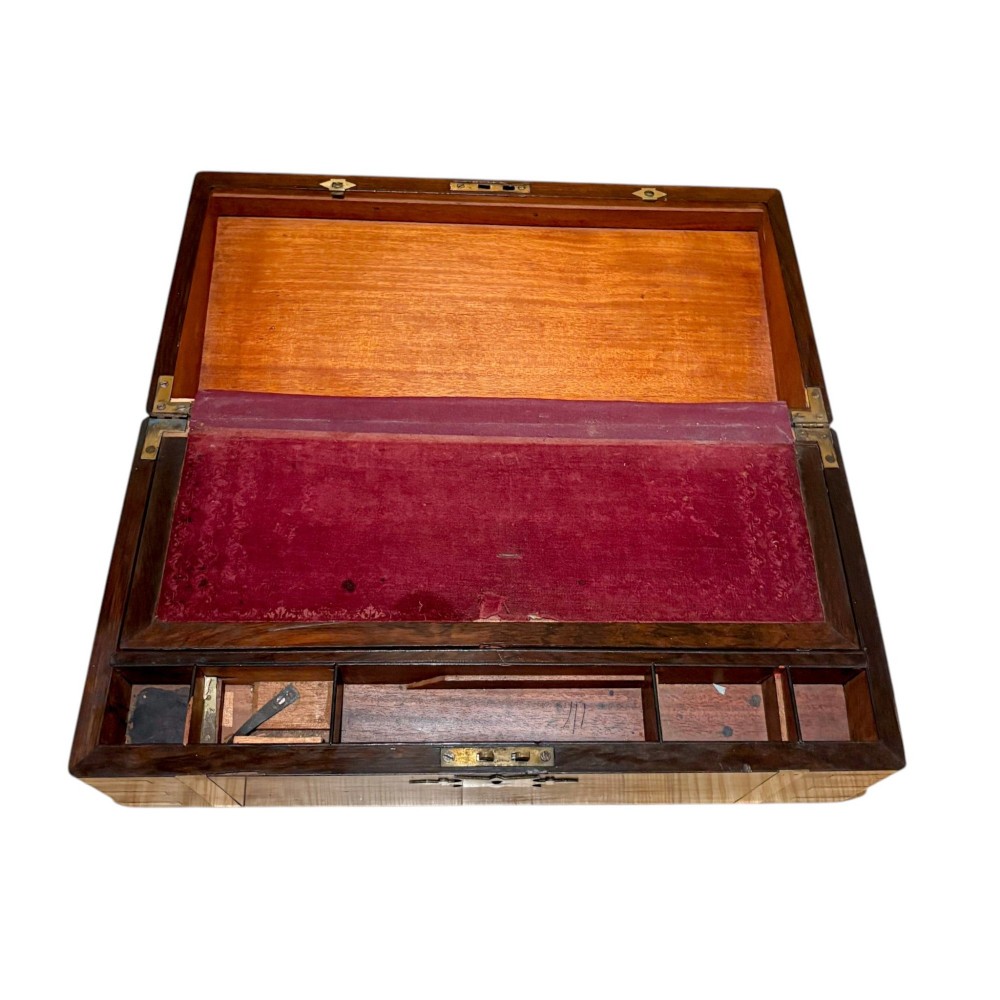 A closed rectangular Victorian rosewood writing slope featuring brass strapping, brass corner mounts, and a central brass escutcheon. View VI