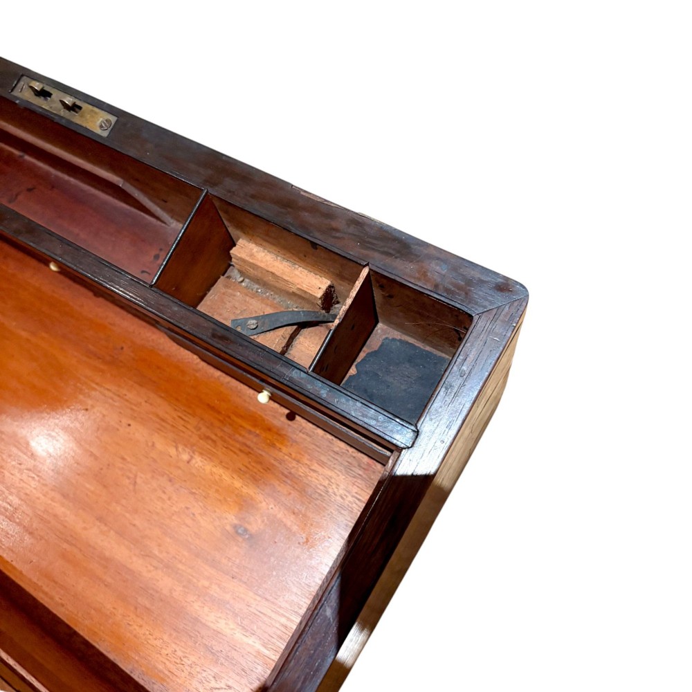 A closed rectangular Victorian rosewood writing slope featuring brass strapping, brass corner mounts, and a central brass escutcheon. View VIII
