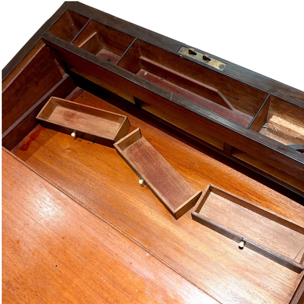 A closed rectangular Victorian rosewood writing slope featuring brass strapping, brass corner mounts, and a central brass escutcheon. View X