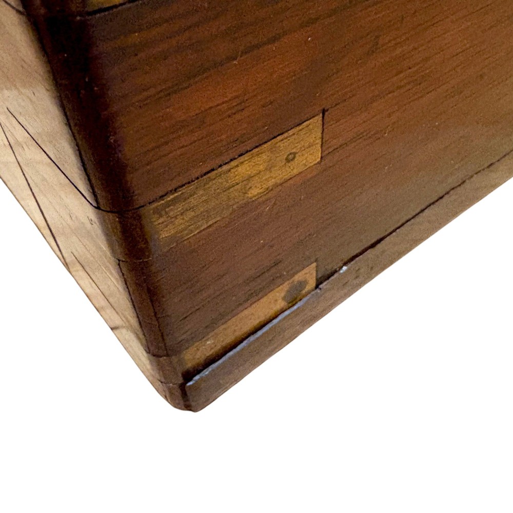 A closed rectangular Victorian rosewood writing slope featuring brass strapping, brass corner mounts, and a central brass escutcheon. View XII