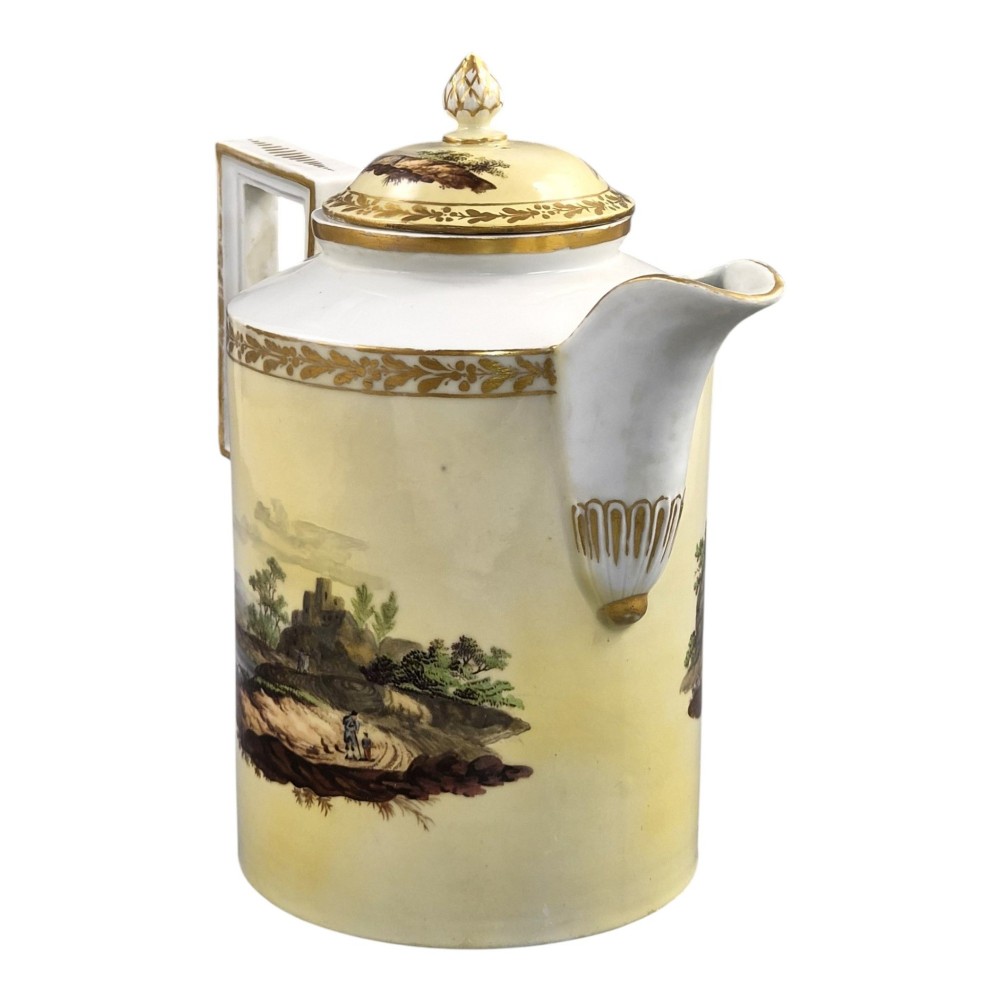 An 18th-century Furstenberg porcelain coffee pot featuring a hand-painted Neoclassical landscape, gold-leaf foliage rim, and an angular gilded handle with a pinecone finial lid. View V