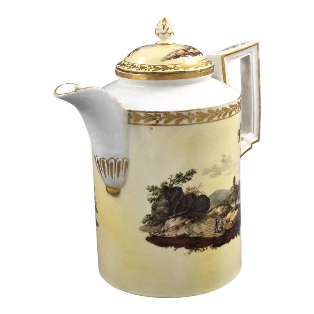 An 18th-century Furstenberg porcelain coffee pot featuring a hand-painted Neoclassical landscape, gold-leaf foliage rim, and an angular gilded handle with a pinecone finial lid. View VI