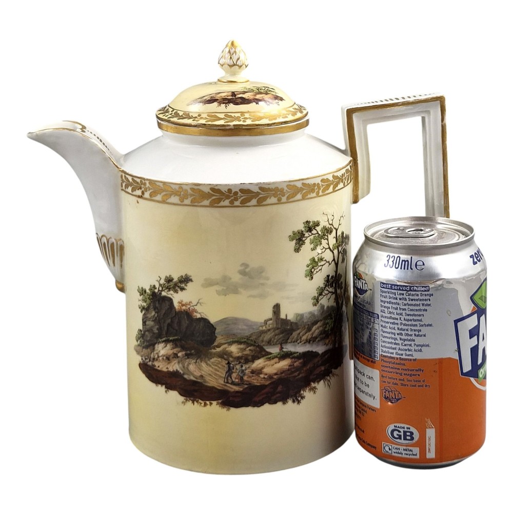 An 18th-century Furstenberg porcelain coffee pot featuring a hand-painted Neoclassical landscape, gold-leaf foliage rim, and an angular gilded handle with a pinecone finial lid. View VII